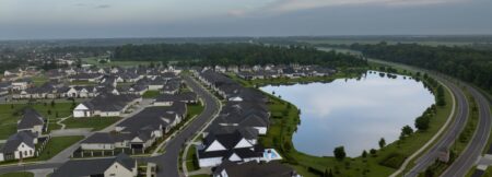 View of homes in The Lakes at Harveston with University Golf Course in the background.